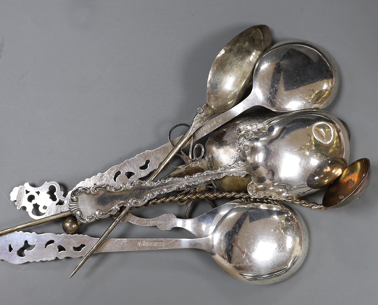 Three 20th century Scandinavian 830 standard white metal ornate spoons, a sterling spoon and three other spoons.